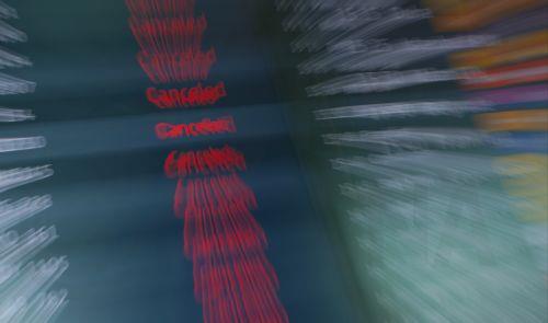 epa12829310 Display boards show canceled flights at Berlin Brandenburg Airport in Schoenefeld, Germany, 18 March 2026. Passenger flight operations were completely suspended due to a one-day warning strike by the Verdi union. According to the airport operator, the strike affects 445 departures and arrivals and around 57,000 passengers. Verdi is currently...