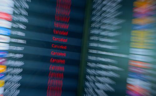 epa12829311 Display boards show canceled flights at Berlin Brandenburg Airport in Schoenefeld, Germany, 18 March 2026. Passenger flight operations were completely suspended due to a one-day warning strike by the Verdi union. According to the airport operator, the strike affects 445 departures and arrivals and around 57,000 passengers. Verdi is currently...