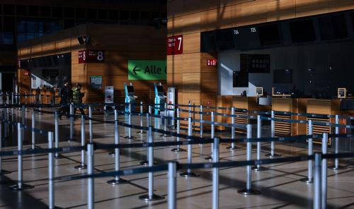 epa12829315 People walk through Terminal 1 of Berlin Brandenburg Airport in Schoenefeld, Germany, 18 March 2026. Passenger flight operations were completely suspended due to a one-day warning strike by the Verdi union. According to the airport operator, the strike affects 445 departures and arrivals and around 57,000 passengers. Verdi is currently...