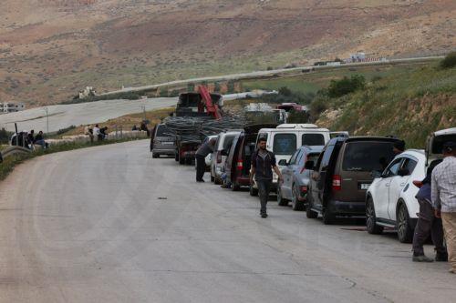 epa12829475 Palestinians wait to cross the Ein Shible checkpoint near the West Bank city of Nablus 18 March 2026.  EPA/ALAA BADARNEH