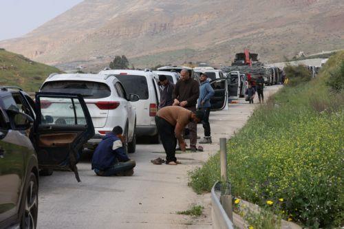 epa12829478 Palestinians wait to cross the Ein Shible checkpoint near the West Bank city of Nablus 18 March 2026.  EPA/ALAA BADARNEH
