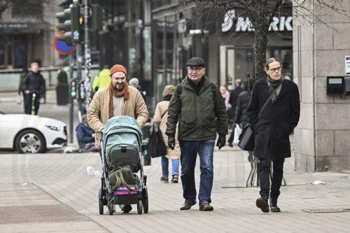 epa12833332 People walk in downtown Helsinki, Finland, 19 March 2026. According to the World Happiness Report 2026, covering 147 countries, Finland has been ranked as the happiest country in the world for the ninth consecutive year.  EPA/KIMMO BRANDT