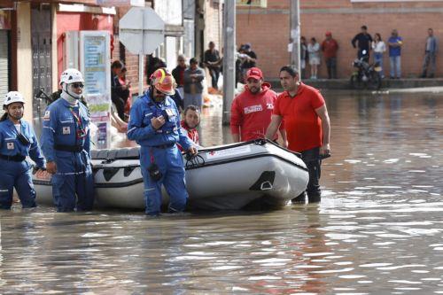 epa12834951 Members of rescue organizations walk through a street flooded by heavy rains in Facatativa, Colombia, 19 March 2026. According to the mayor of Facatativa, Luis Carlos Casas, and local emergency agencies, heavy rains caused the Mancilla and San Rafael creeks to overflow and feed the Botello River, leading to severe flooding that affected more...