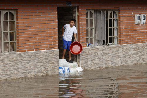 epa12834958 A child observes a street flooded by heavy rains in Facatativa, Colombia, 19 March 2026. According to the mayor of Facatativa, Luis Carlos Casas, and local emergency agencies, heavy rains caused the Mancilla and San Rafael creeks to overflow and feed the Botello River, leading to severe flooding that affected more than 2,000 families. ...