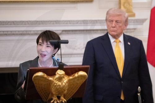 epa12834976 United States President Donald Trump stands with Prime Minster Takeuchi Sanae of Japan as she makes remarks during a bilateral state dinner in the State Dining Room of the White House in Washington DC, USA, 19 March 2026. Earlier in the day, Trump and Takeuchi exchanged views on Iran, energy and issues in the Indo-Pacific region.  EPA/AARON...