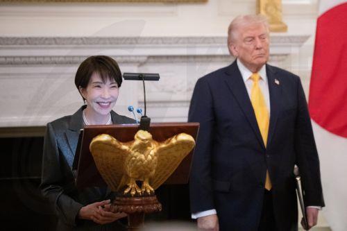 epa12834978 United States President Donald Trump stands with Prime Minster Takeuchi Sanae of Japan as she makes remarks during a bilateral state dinner in the State Dining Room of the White House in Washington DC, USA, 19 March 2026. Earlier in the day, Trump and Takeuchi exchanged views on Iran, energy and issues in the Indo-Pacific region.  EPA/AARON...
