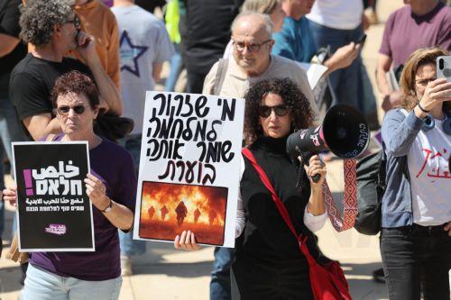 epa12835871 Anti-government protesters hold a sign in Hebrew reading 'whoever needs the war keeps it burning' during a protest against the war with Iran calling for the end of the war, in Tel Aviv, Israel, 20 March 2026. US and Israel launched a joint military operation targeting multiple locations across Iran in the early hours of 28 February 2026, with...