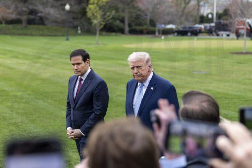 epa12837378 US President Donald J. Trump (C), with Secretary of State Marco Rubio (L), responds to a question from the news media as he walks to board Marine One on the South Lawn of the White House in Washington, DC, USA, 20 March 2026.  EPA/SHAWN THEW / POOL