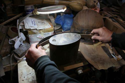 epa12838019 Nikolas Bras heats veneer strips — ribs  — to bend them so they can be placed onto the bowl of a bouzouki under completion in his workshop, where he has been working for approximately 40 years crafting handmade stringed instruments, in Athens, Greece, 26 February 2026 (issued 21 March 2026). The customized shape of these hand-crafted...