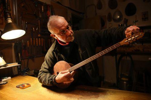 epa12838022 Panagiotis Kafetzopoulos, a maker of handmade stringed instruments, tunes a stringed instrument of his own creation in his workshop in Exarcheia district, Athens, Greece, 26 February 2026 (issued 21 March 2026). The instruments Panagiotis Kafetzopoulos designs and produces are highly distinguished by their excellent craftsmanship and...