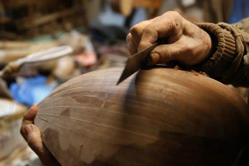 epa12838024 Nikolas Bras sands the bowl of a bouzouki still in the making, in his workshop where he has been working for approximately 40 years crafting handmade stringed instruments, in Athens, Greece, 26 February 2026 (issued 21 March 2026). The customized shape of these hand-crafted instruments, their construction materials, the unique timbre they...