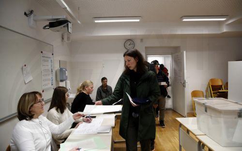 epa12841301 Slovenian citizens vote during the parliamentary election at a polling station in Ljubljana, Slovenia, 22 March 2026. The 22 March 2026 parliamentary election follows reports of an alleged covert operation by the Israeli intelligence firm Black Cube to influence the vote.  EPA/ANTONIO BAT