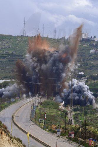 epa12841452 Smoke and flames rise after an Israeli strike targeting the Qasmiya Bridge near Tyre, in southern Lebanon, 22 March 2026. According to the Lebanese National News Agency (NNA), the Israeli military carried out an airstrike on the Qasmiya Bridge, a key crossing point over the Litani River connecting southern Lebanon to the north.  EPA/STRINGER