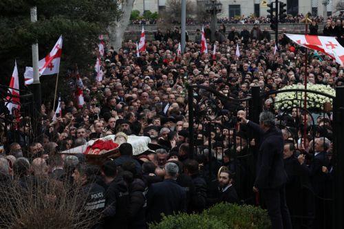 epa12841481 Mourners follow the coffin of the late Georgia's Orthodox Patriarch Ilia II as clergy carry it into the Sioni Cathedral during his funeral ceremony in Tbilisi, Georgia, 22 March 2026. Catholicos-Patriarch Ilia II (Irakli Gudushauri-Shiolashvili) of All Georgia died on 17 March, at the age of 93 in Tbilisi. He had led the Georgian Orthodox Church...