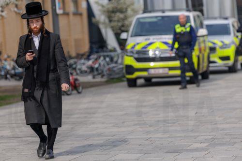 epa12843692 A member of the Jewish community walks on a street in Antwerp, Belgium, 23 March 2026. The Belgian government announced on 16 March that it will deploy military personnel to reinforce the Federal Police to protect a number of synagogues and Jewish schools across the country following a series of antisemitic attacks in Europe.  EPA/OLIVIER MATTHYS