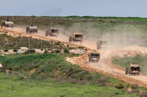 epaselect epa12848526 Israeli military vehicles maneuver on the Lebanese side of the border, as seen from the Upper Galilee in northern Israel, 25 March 2026. The Israeli military stated it is conducting strikes across Lebanon targeting Hezbollah infrastructure and personnel.  EPA/ATEF SAFADI