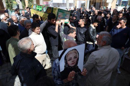 epa12850871 Iranians carry a coffin during the funeral for victims of the conflict between Iran, Israel and the US, at the Behesht Zahra cemetery in southern Tehran, Iran, 26 March 2026. A joint Israeli and US military operation continues to target multiple locations across Iran, since the early hours of 28 February 2026.  EPA/ABEDIN TAHERKENAREH