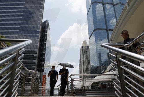 epa12859925 Office workers walk with umbrellas to shield themselves from the sun during hot weather in Bangkok, Thailand, 30 March 2026. The Meteorological Department reports that Thailand is experiencing extreme heat and urges the public to avoid outdoor activity while the Digital Economy and Society Ministry warns the country's heat index is forecasted to...