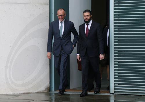 epa12860002 German Chancellor Friedrich Merz (L) and Syrian President Ahmed al-Sharaa emerge on the terrace of the Chancellery prior to talks in Berlin, Germany, 30 March 2026. The Syrian president is on his first official state visit to Germany.  EPA/SEAN GALLUP / POOL