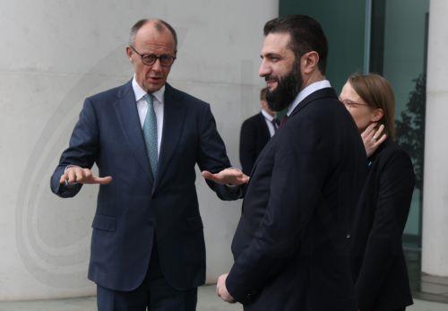 epa12860003 German Chancellor Friedrich Merz (L) and Syrian President Ahmed al-Sharaa (R) chat on the terrace of the Chancellery prior to talks in Berlin, Germany, 30 March 2026. The Syrian president is on his first official state visit to Germany.  EPA/SEAN GALLUP / POOL