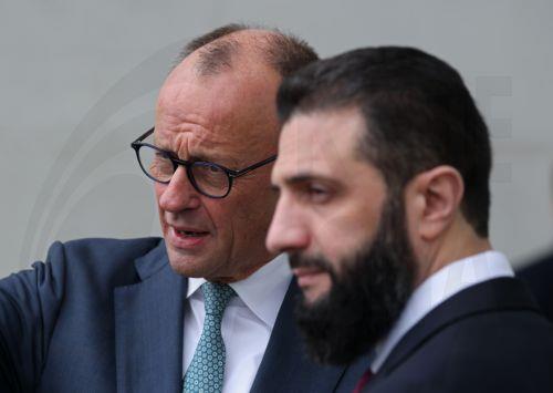 epa12860005 German Chancellor Friedrich Merz (L) and Syrian President Ahmed al-Sharaa (R) chat on the terrace of the Chancellery prior to talks in Berlin, Germany, 30 March 2026. The Syrian president is on his first official state visit to Germany.  EPA/SEAN GALLUP / POOL