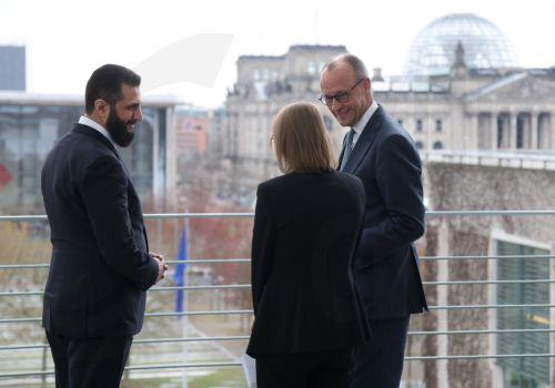 epa12860008 German Chancellor Friedrich Merz (R) and Syrian President Ahmed al-Sharaa (L) chat on the terrace of the Chancellery prior to talks in Berlin, Germany, 30 March 2026. The Syrian president is on his first official state visit to Germany.  EPA/SEAN GALLUP / POOL