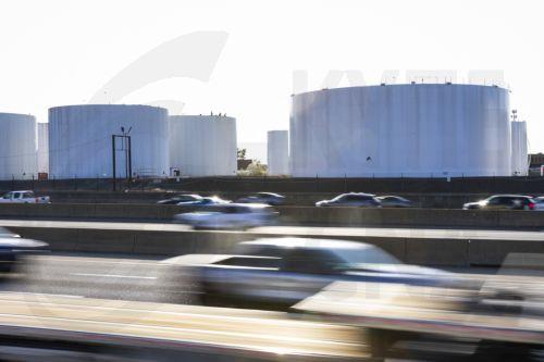 epa12862027 Traffic passes fuel storage tanks holding gasoline, jet fuel, and diesel at the Newington fuel terminal in Lorton, Virginia, USA, 31 March 2026. The Iran war has raised average gas prices in the US above four dollars a gallon for the first time since 2022.  EPA/JIM LO SCALZO