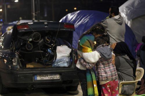 epa12866510 A family packs their belongings before returning to devastated areas of the southern suburb of Beirut, Lebanon, 02 April 2026. Adverse weather, heavy rain, and a shortage of tents forced some residents to return to their homes despite Israeli warnings and ongoing airstrikes. According to the UN, more than 1.1 million people have been displaced...
