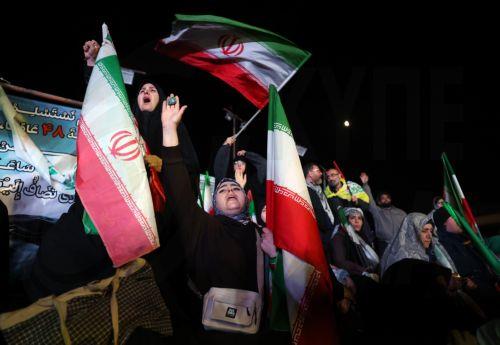 epaselect epa12874354 Iranians wave flags during a demonstration following the announcement of a two-week ceasefire at Enghelab Square in Tehran, Iran, 08 April 2026. Iran and the USA agreed to the two-week truce to halt military operations and keep the Strait of Hormuz open for oil and gas shipments, with formal peace talks set to begin in Islamabad on 10...