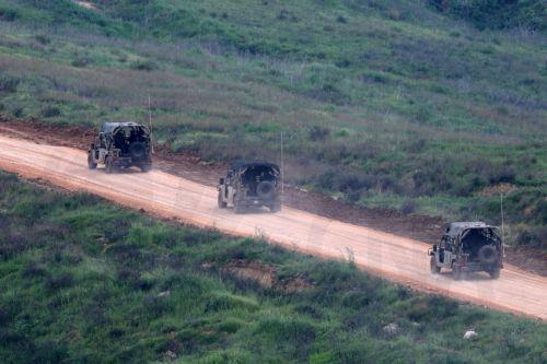 epa12877166 Israeli military vehicles drive on the Lebanese side of the border, as seen from the upper Galilee on the Israel-Lebanon border, 09 April 2026. The Israeli military said it continued targeting operations of Hezbollah in southern Lebanon.  EPA/ATEF SAFADI