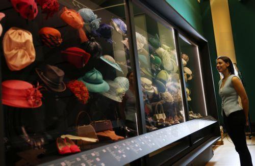 epa12877222 A gallery worker poses with hats worn by Britain’s Queen Elizabeth II that are displayed at the exhibition 'Queen Elizabeth II: Her Life in Style' at The King’s Gallery, Buckingham Palace in London, Britain, 09 April 2026. The exhibition features 300 pieces of clothing and accessories worn by late Britain’s Queen Elizabeth and runs from 10 April...