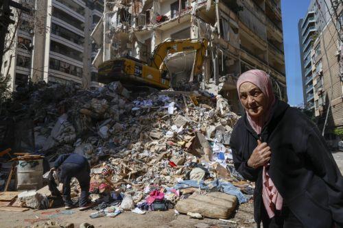 epaselect epa12877036 A woman walks next to a destroyed residential building the day after an Israeli airstrike in the Ain Mreisseh neighborhood of Beirut, Lebanon, 09 April 2026. At least 182 people were killed and more than 890 others injured after Israeli airstrikes hit multiple locations across Lebanon on 08 April, the Lebanese Ministry of Health...