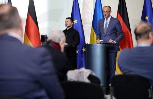 epa12888853 German Chancellor Friedrich Merz (C-R) and Ukrainian President Volodymyr Zelensky (C-L) attend a press conference at the Chancellery in Berlin, Germany, 14 April 2026. Following the Hungarian elections on 12 April, the German government expects that the EU’s 90 billion euro loan package for Ukraine will be unblocked swiftly.  EPA/HANNIBAL...