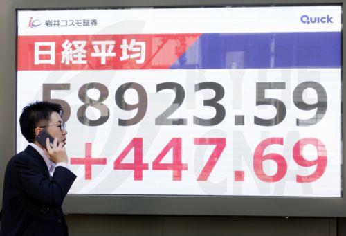 epa12901637 A passerby walks past a stock market indicator board in Tokyo, Japan, 20 April 2026. Tokyo stocks rose slightly on optimism over possible Middle East peace talks.  EPA/FRANCK ROBICHON