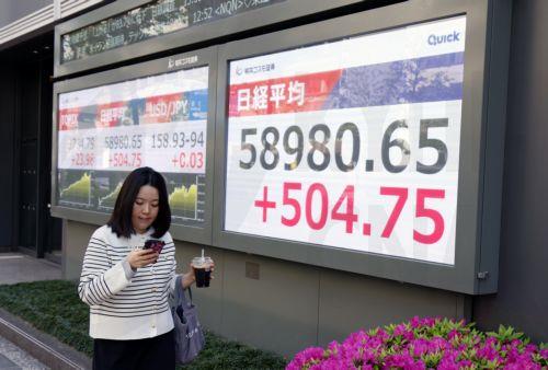 epa12901639 A passerby walks past a stock market indicator board in Tokyo, Japan, 20 April 2026. Tokyo stocks rose slightly on optimism over possible Middle East peace talks.  EPA/FRANCK ROBICHON