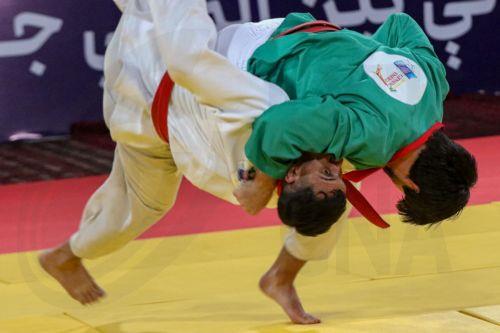 epa12916001 An Afghan (green) and Tajik wrestler in action during the International Traditional Wrestling Festival in Kabul, Afghanistan, 26 April 2026. An international traditional wrestling tournament was held in Kabul, where around 160 athletes from seven countries competed over three days across multiple weight categories.  EPA/SAMIULLAH POPAL