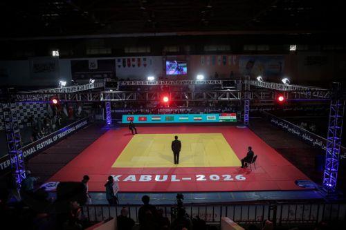 epa12916010 Judges stand on the mat during the International Traditional Wrestling Festival in Kabul, Afghanistan, 26 April 2026. An international traditional wrestling tournament was held in Kabul, where around 160 athletes from seven countries competed over three days across multiple weight categories.  EPA/SAMIULLAH POPAL