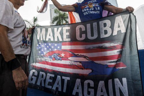 epa12916199 A participant holds up a banner during the Save Cuba rally in Miami, Florida, USA, 26 April 2026. Save Cuba is a rally organized by Miami's Cuban community to call for a political transition in Cuba.  EPA/CRISTOBAL HERRERA-ULASHKEVICH
