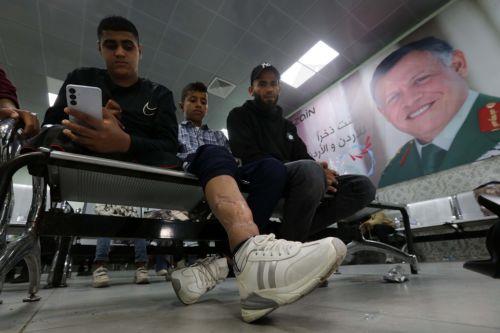 epa12918022 Wounded Palestinians are seen as evacuees from Gaza arrive for medical treatment at the King Hussein Bridge crossing in South Shuna, Jordan, 27 April 2026. A group of at least 81 injured people from the Gaza Strip arrived in Jordan for medical care, accompanied by 108 parents and family members. The evacuation is part of a humanitarian effort to...