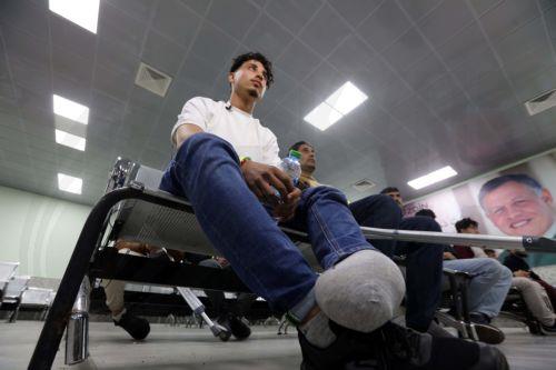 epa12918026 A wounded Palestinian is seen as evacuees from Gaza arrive for medical treatment at the King Hussein Bridge crossing in South Shuna, Jordan, 27 April 2026. A group of at least 81 injured people from the Gaza Strip arrived in Jordan for medical care, accompanied by 108 parents and family members. The evacuation is part of a humanitarian effort to...