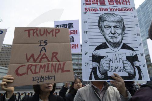 epa12920812 South Korean protesters hold banners and a mugshot of U.S. President Donald Trump during a demonstration against U.S. and Israeli military actions in Iran outside the U.S. embassy in Seoul, South Korea, 29 April 2026.  EPA/JEON HEON-KYUN