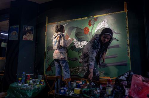 epa12922460 Palestinian Joud Mohammed (R), 18, and Rahaf Al-Halabi (L), 18, paint together inside a small cafe in Gaza City, 29 April 2026. The two teenagers use their artwork as a means of self-expression and to provide financial support for their families amid ongoing economic hardship. With Gaza's educational system largely paralyzed since the outbreak...