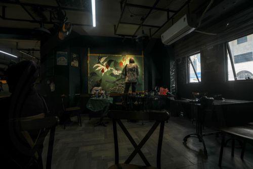 epa12922461 Palestinian Joud Mohammed (R), 18, and Rahaf Al-Halabi (L), 18, paint together inside a small cafe in Gaza City, 29 April 2026. The two teenagers use their artwork as a means of self-expression and to provide financial support for their families amid ongoing economic hardship. With Gaza's educational system largely paralyzed since the outbreak...
