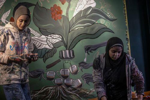 epaselect epa12922458 Palestinian Joud Mohammed (R), 18, and Rahaf Al-Halabi (L), 18, paint together inside a small cafe in Gaza City, 29 April 2026. The two teenagers use their artwork as a means of self-expression and to provide financial support for their families amid ongoing economic hardship. With Gaza's educational system largely paralyzed since the...