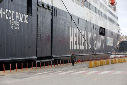 epa12926127 A man walks at the harbor passing by a docked ferry during a 24-hour general strike marking the International Labor Day in the port of Piraeus near Athens, Greece, on 01 May 2026. Public transport workers participate in the strikes taking place on May 1, demanding collective agreements with real wage increases, the recruitment of permanent staff...