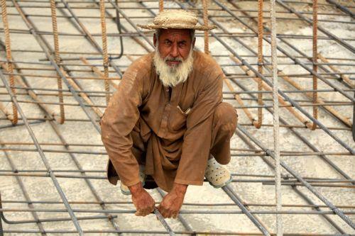 epa12926159 A Pakistani laborer poses for a portrait as he works at a construction site during International Workers' Day, on the outskirts of Peshawar, Khyber Pakhtunkhwa (KPK) province, Pakistan, 01 May 2026. Labor Day, or May Day, observed annually around the globe on 01 May, celebrates laborers, their rights, achievements, and contributions to society....