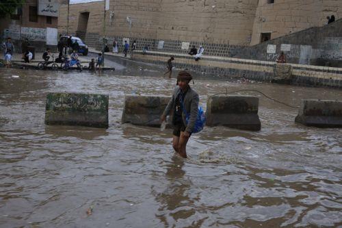 epa12929030 A person wades through a flooded street following torrential rainfall in Sana'a, Yemen, 02 May 2026. Yemen's National Center of Meteorology and Early Warning has warned of further heavy rains and possible flooding across much of the country.  EPA/YAHYA ARHAB