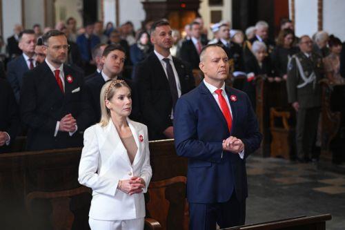 epa12929430 Polish President Karol Nawrocki (R) and First Lady Marta Nawrocka (L) attend a Holy Mass for the Homeland as part of 3rd May Constitution Day celebrations at the Archcathedral of St. John the Baptist in Warsaw, Poland, 03 May 2026The 03 May National Holiday commemorates the adoption of the 03 May Constitution in 1791. This document was the...