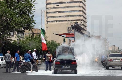 epa12938641 People help a driver extinguish a fire in the engine of his car on a street in Tehran, Iran, 07 May 2026. US President Donald Trump announced a pause in the operation of escorting ships through the Strait of Hormuz, signaling progress in peace talks with Tehran.  EPA/ABEDIN TAHERKENAREH