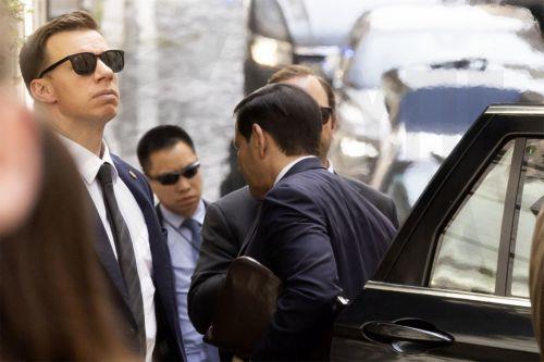 epa12938748 US Secretary of State Marco Rubio is escorted by security as he arrives at his hotel in Rome, Italy, 07 May 2026. Rubio is in the Italian capital for high-level meetings with Vatican and Italian officials.  EPA/MASSIMO PERCOSSI